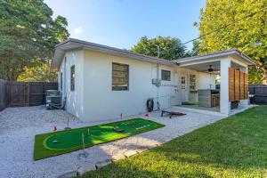 a house with a miniature golf course in the yard at Bright and Cozy Home in Homestead in Homestead +39 photos