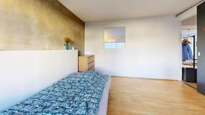 a bedroom with a bed with a blue comforter at Nimastay - Central Aalborg Haven in Aalborg