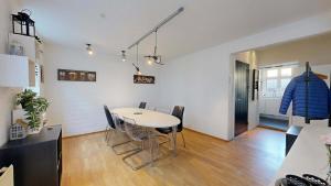 a kitchen and dining room with a table and chairs at Nimastay - Central Aalborg Haven in Aalborg +11 photos
