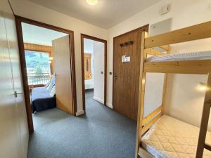 a room with two bunk beds and a bedroom at Appartement 2 pièces cabine avec balcon, proche village et pistes - Praz Sur Arly - 5 pers. - FR-1-603-101 in Praz-sur-Arly