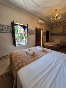 A bed or beds in a room at Riad Rime Garden Marrakech