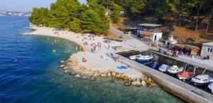a group of people on a beach in the water at Apartment Tea 2 in Okrug Donji +12 photos