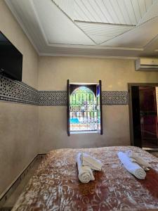 A bed or beds in a room at Riad Rime Garden Marrakech
