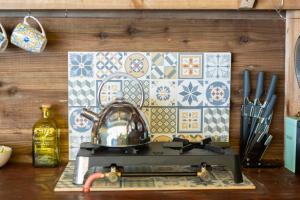 a kitchen counter with a tea kettle on a stove at Luxury Glamping The Wye Valley for 2 to 4 Guests in Ross on Wye