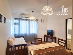 a living room with a table and a dining room at Las Tulmas Apartamentos Salta in Salta