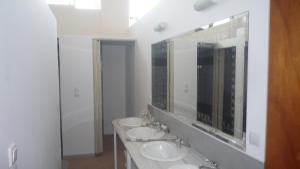 a bathroom with three sinks and a large mirror at Hostel Stylianos Kissamos in Kissamos +51 photos