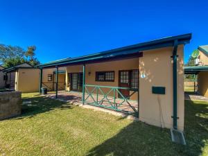 a building with a gate in a yard at Pandleberry in Warmbaths +4 photos