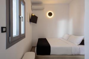 Postel nebo postele na pokoji v ubytování Tataki Family Hotel