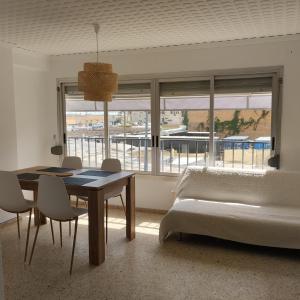 a living room with a table and a bed and a table and chairs at Burrianna Beach Apartment in Burriana