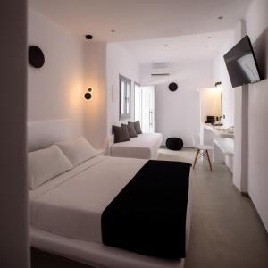 Postel nebo postele na pokoji v ubytování Tataki Family Hotel