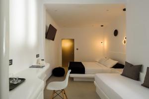 Postel nebo postele na pokoji v ubytování Tataki Family Hotel