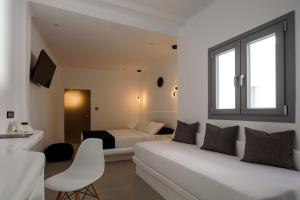 Postel nebo postele na pokoji v ubytování Tataki Family Hotel