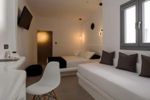 Postel nebo postele na pokoji v ubytování Tataki Family Hotel
