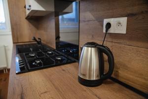 a tea kettle sitting on a counter next to a stove at Privat Agapi in Vrbov