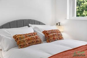 a white bed with white pillows and a window at Flat in Old Trafford Manchester in Manchester