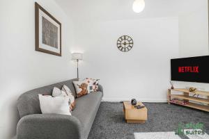 a living room with a couch and a tv at Flat in Old Trafford Manchester in Manchester