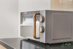 a microwave oven sitting on top of a counter at Flat in Old Trafford Manchester in Manchester