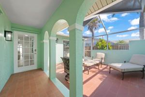 a room with a patio with two chairs and a table at Tipsy Turtle in Sanibel