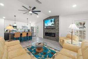 a living room with two couches and a fireplace at Tipsy Turtle in Sanibel
