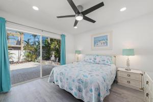 a bedroom with a bed and a ceiling fan at Tipsy Turtle in Sanibel