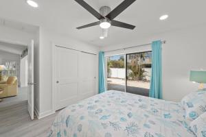 a bedroom with a bed and a ceiling fan at Tipsy Turtle in Sanibel