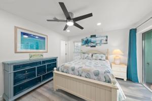 a bedroom with a bed and a ceiling fan at Tipsy Turtle in Sanibel