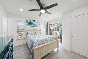 a bedroom with a bed and a ceiling fan at Tipsy Turtle in Sanibel