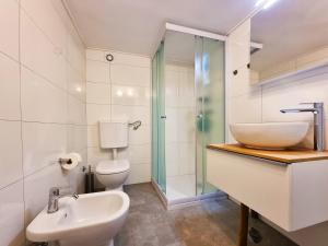 a bathroom with a sink and a toilet and a shower at Bruno's Rooms in Bašanija