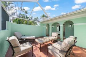 a room with chairs and a table and windows at Tipsy Turtle in Sanibel