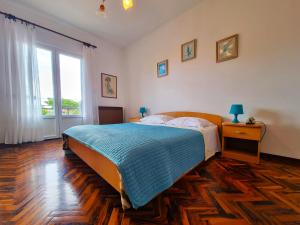 a bedroom with a bed and a large window at Bruno's Rooms in Bašanija