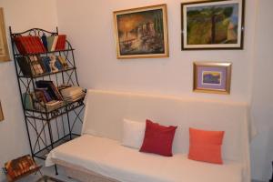 a white couch with two red pillows in a room at Apartments Villa Nada in Sutivan +15 photos