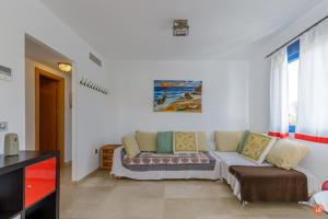 a living room with a couch and a window at Views of the Blue in Torrox