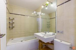 a bathroom with a sink and a toilet and a tub at Views of the Blue in Torrox