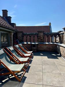 a row of lounge chairs sitting on a patio at Holiday home Nieuwpoort in Nieuwpoort