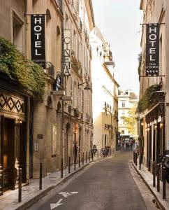 an empty street in a city with buildings at Hotel Residence Des Arts in Paris