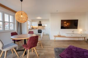 レーメにあるFerienhaus Uhlenhorstのテーブルと椅子のあるダイニングルームとリビングルーム