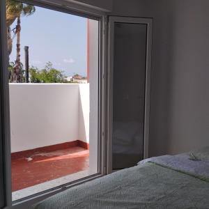 a bedroom with a sliding glass door to a balcony at Burrianna Beach Apartment in Burriana +7 photos