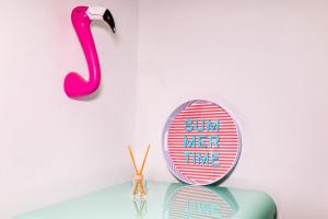 a mirror and a pink flamingo on a table at Kuća Koza-Apartment Elisa in Punat