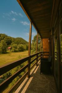 a porch of a house with a bench on it at Cabana Riverdale in Podu Dîmboviţei