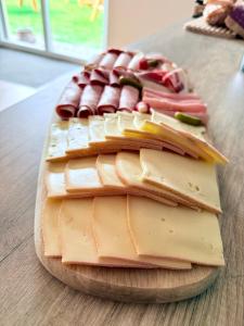 a pile of cheese on a wooden cutting board at Charda Spa in Seyne +14 photos