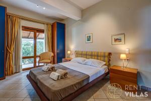 a bedroom with a bed with towels on it at Beachfront Villa Armonia in Porto Hydra by goutos properties in Ermioni