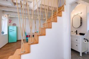 a staircase in a kitchen with a green refrigerator at Kuća Koza-Apartment Elisa in Punat +28 photos