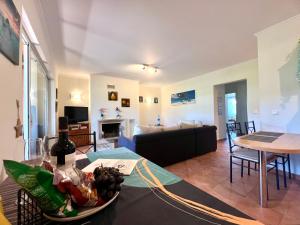 a living room with a couch and a table at Golf and Beach Serenity in Aroeira