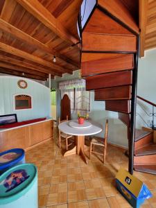 a living room with a table and a staircase at Pousada girassol comp in Urubici