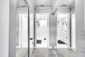 a white bathroom with a mirror and a sink at Unique Stays at Cozy Lake House near Universal in Orlando +24 photos