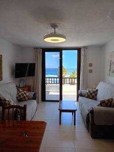 a living room with a view of the ocean at Parque Santiago II 379 Tenerife Rental & Sales in Playa de las Americas
