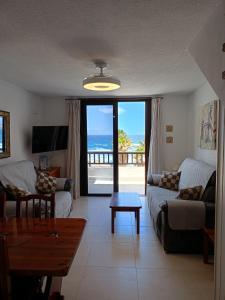 a living room with a view of the ocean at Parque Santiago II 379 Tenerife Rental & Sales in Playa de las Americas