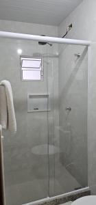 a shower with a glass door in a bathroom at recanto Provetá 2 ILHA GRANDE in Praia de Provetá 