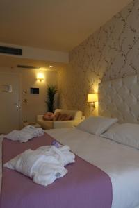 a hotel room with a bed and a couch at Hotel Palazzo Bello in Recanati