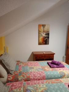 a bedroom with a bed and a wooden dresser at Parque Santiago II 379 Tenerife Rental & Sales in Playa de las Americas +31 photos